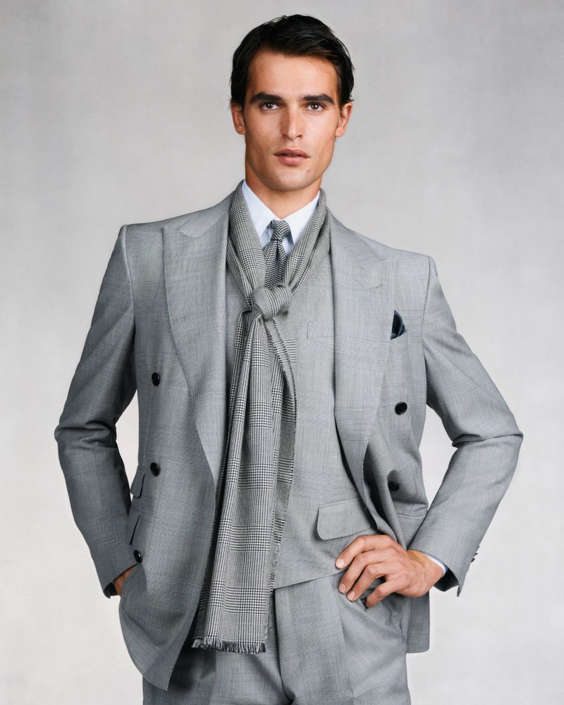 Parker Van Noord wearing a grey double-breasted suit and matching scarf for Dunhill by Ethan James Green
