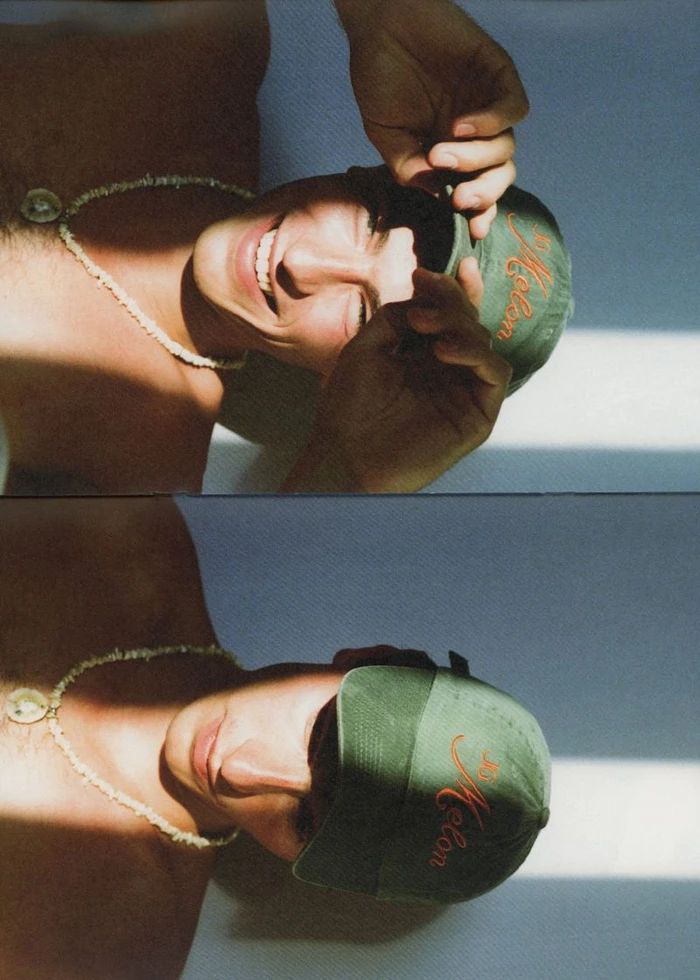 Two-panel vertical portrait of a shirtless man wearing a green baseball cap and shell necklace under striped sunlight shadows.