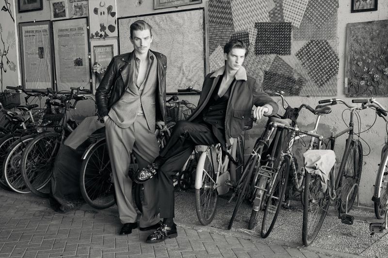 Two male models posing amongst parked bicycles in a black and white editorial photograph for Issue South America