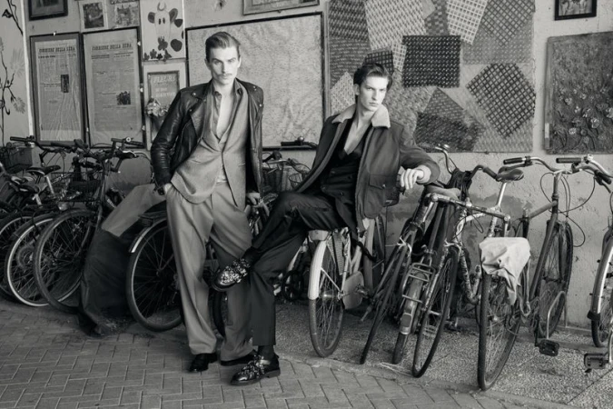 Two male models posing amongst parked bicycles in a black and white editorial photograph for Issue South America