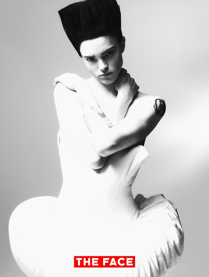 Model Malte Carlsson posing with crossed arms in a sculptural white corset dress and tall flattop hair for The Face China.