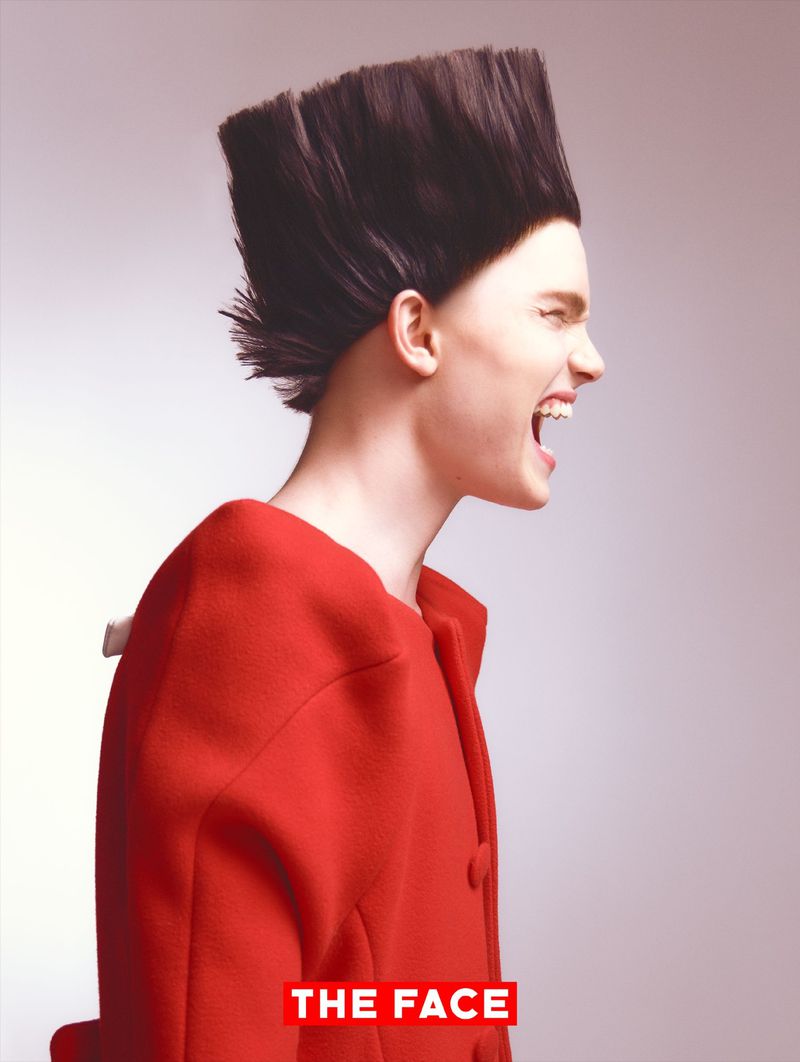 Side profile of model Malte Carlsson shouting in a bright red coat with an avant-garde flat-top hairstyle against a light grey background.