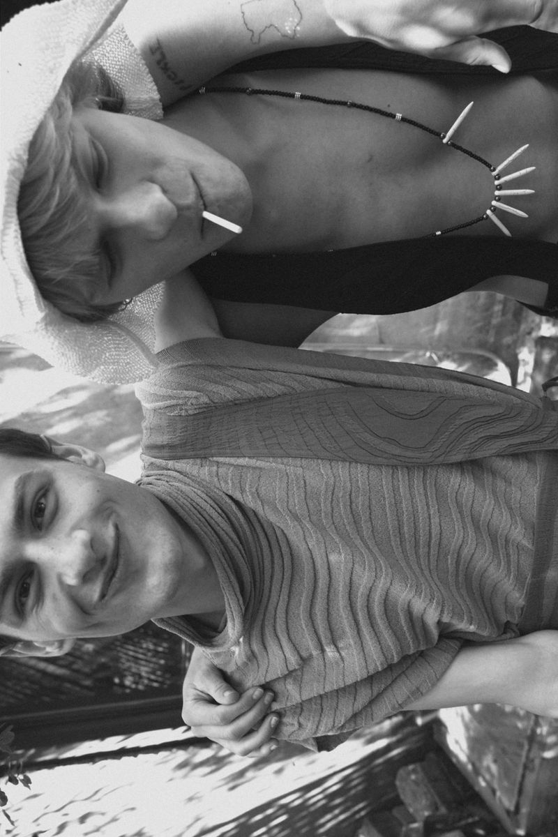 Black and white portrait of models Isaac Kaplan and Audi Bizar posing together outdoors for Harper's Bazaar Thailand Men.