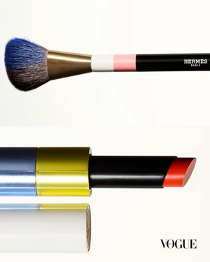 Close-up still life of a makeup brush and lipstick against a bright white background.