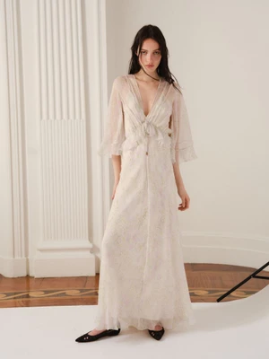 Clara Denison wearing a sheer flowing v-neck gown and black flat shoes for Alberta Ferretti Resort 2026.