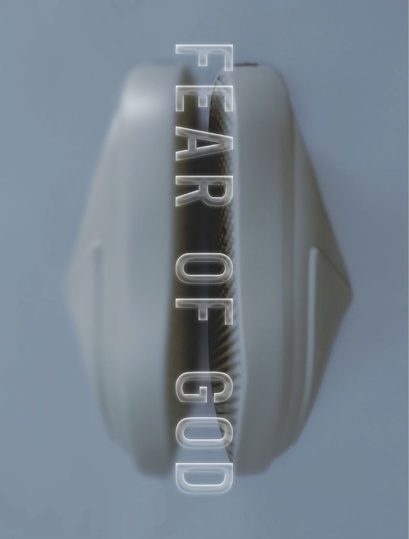 Top-down view of Fear of God sculpted foam slip-on shoes with translucent typography overlaid on a grey background.