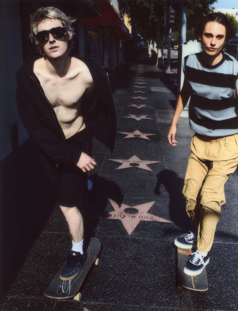 Two young men skateboarding along the Hollywood Walk of Fame in streetwear for Glass Magazine.
