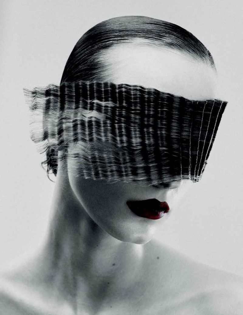 Close-up portrait of a woman with slicked hair and dark red lips, her eyes obscured by horizontal glass distortion.