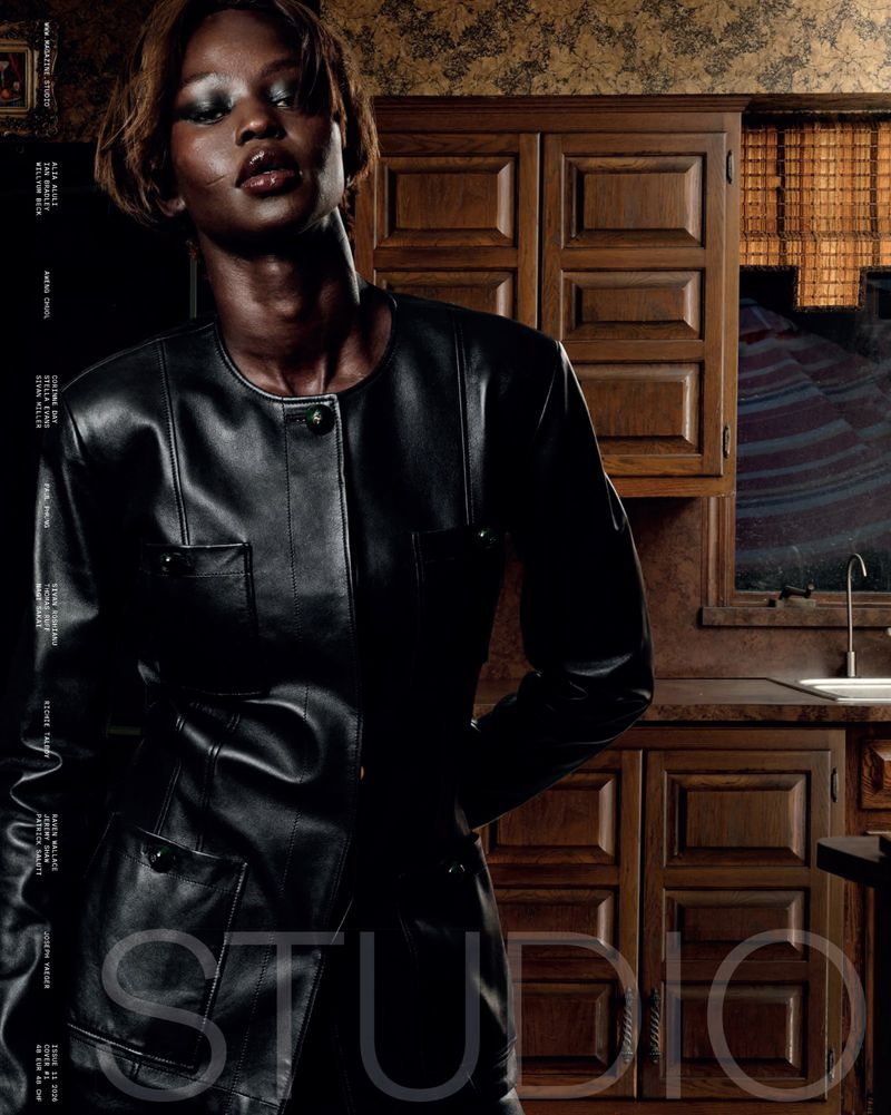 Model Aweng Chuol wearing a black leather jacket in a domestic kitchen setting for Studio Magazine editorial