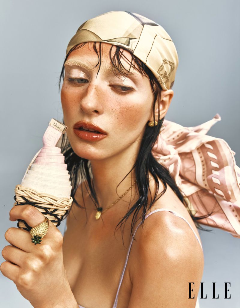 Model Hannah Vincent wearing a printed headscarf and holding a styled cone prop in an editorial for Elle China.