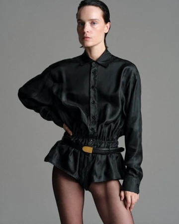 Model Charlotte Tomas wearing a black silk blouse and shorts styled by Julie Pelipas for BETTTER F/W 2026