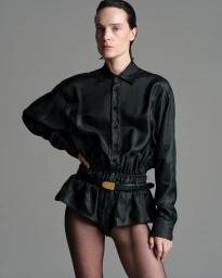 Model Charlotte Tomas wearing a black silk blouse and shorts styled by Julie Pelipas for BETTTER F/W 2026
