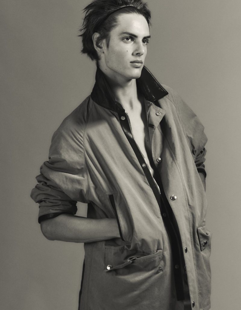 Model Esteban Monbaliu wearing an open oversized utility jacket with hands in pockets in a studio portrait for El Pais Icon Magazine.