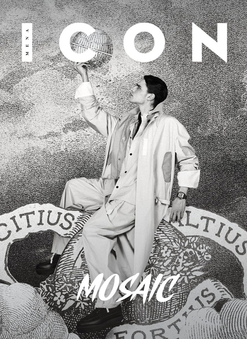 Model Tancrede Scalabre wearing an oversized light coat and trousers on the black and white cover of ICON Magazine Mena.