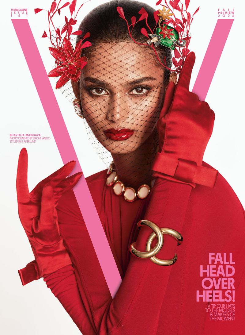 Bhavitha Mandava wearing red satin gloves, a floral headpiece, black mesh veil, and gold jewellery for V Magazine.