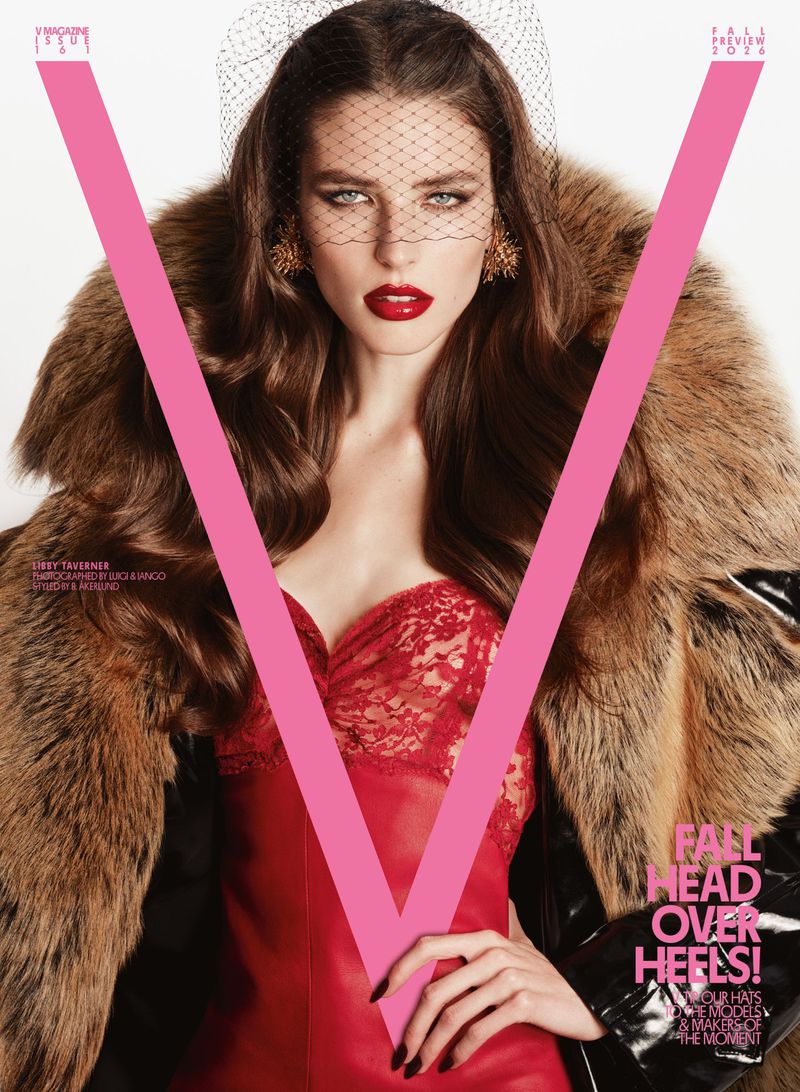Model wearing a red lace corset, netting face veil, and a voluminous brown fur coat on the cover of V Magazine.