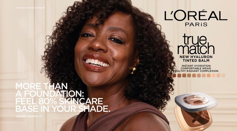 Viola Davis smiling in a brown top for the L'Oreal Paris True Match Hyaluron Tinted Balm campaign.