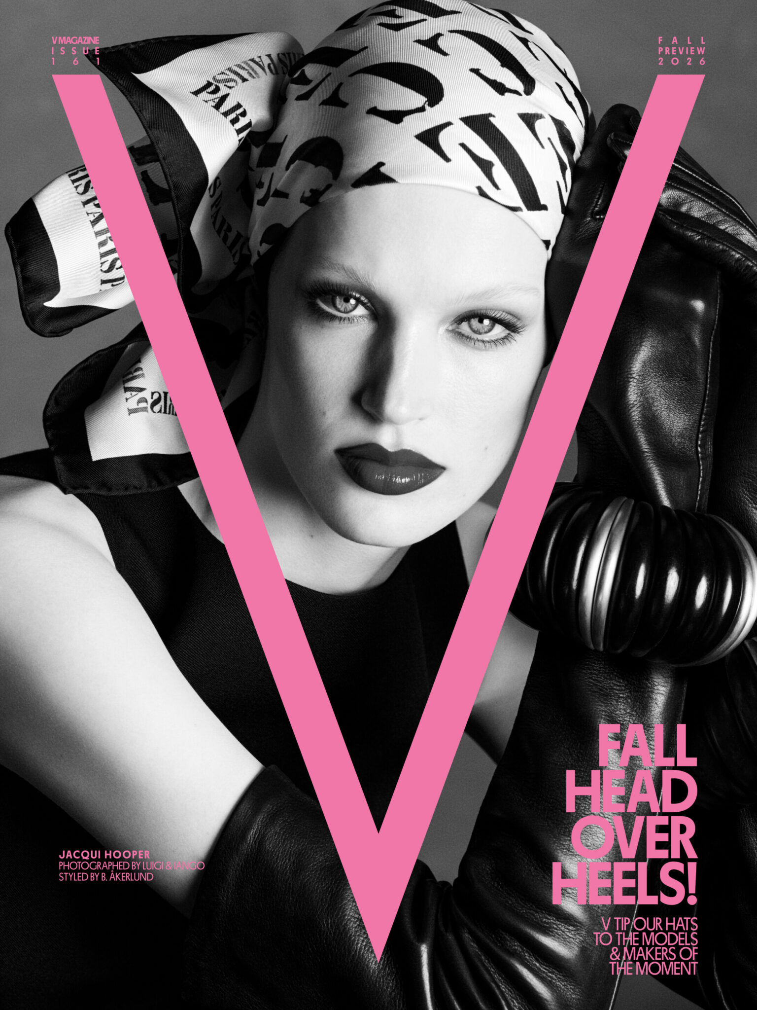 Model Jacqui Hooper wearing a printed silk headscarf, dark lipstick, and black leather gloves under a large pink V Magazine logo.