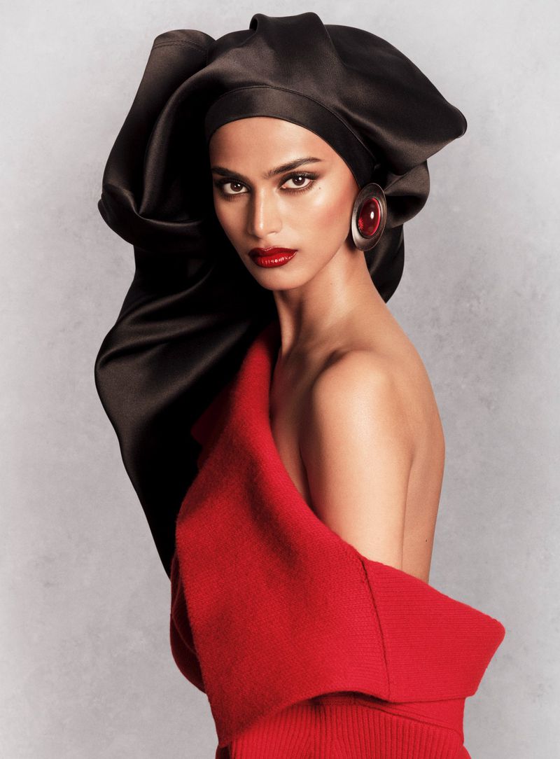 Model Bhavitha Mandava wearing a dramatic black satin headpiece and red top for V Magazine photographed by Luigi & Iango.