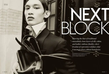 Model Eden Huang posing in a dark blazer with an oversized white collar and black leather bag for Vogue Man Philippines.