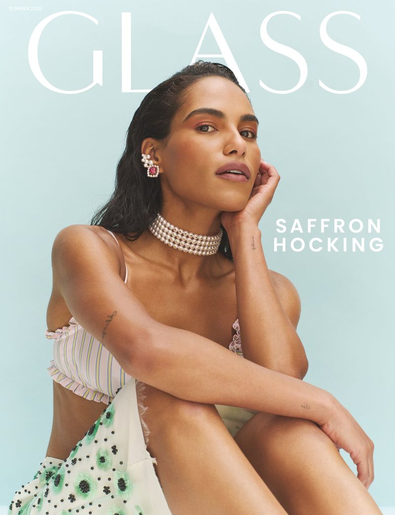 Saffron Hocking wearing a multi-strand pearl choker necklace and crop top on the cover of Glass Magazine against a pale blue background.