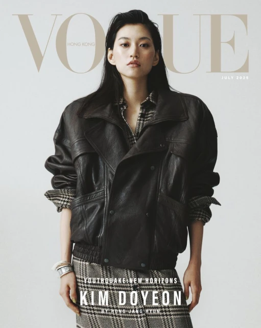 Vogue Hong Kong cover featuring Kim Doyeon, full-length shot in a dark leather jacket and plaid skirt against a bright background.