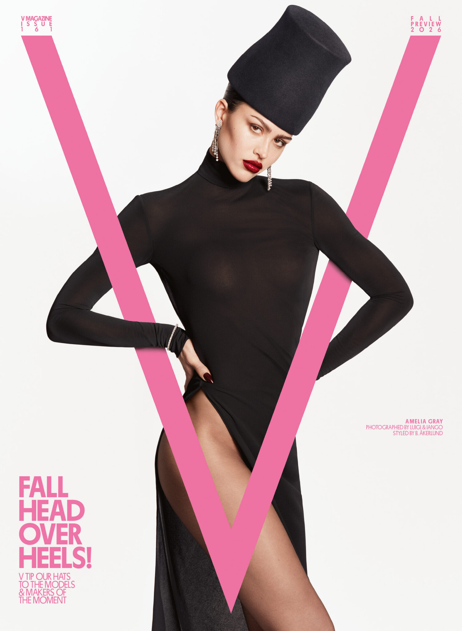 Amelia Gray wearing a black high-neck bodysuit and tall black cylindrical hat for V Magazine against a white seamless backdrop.