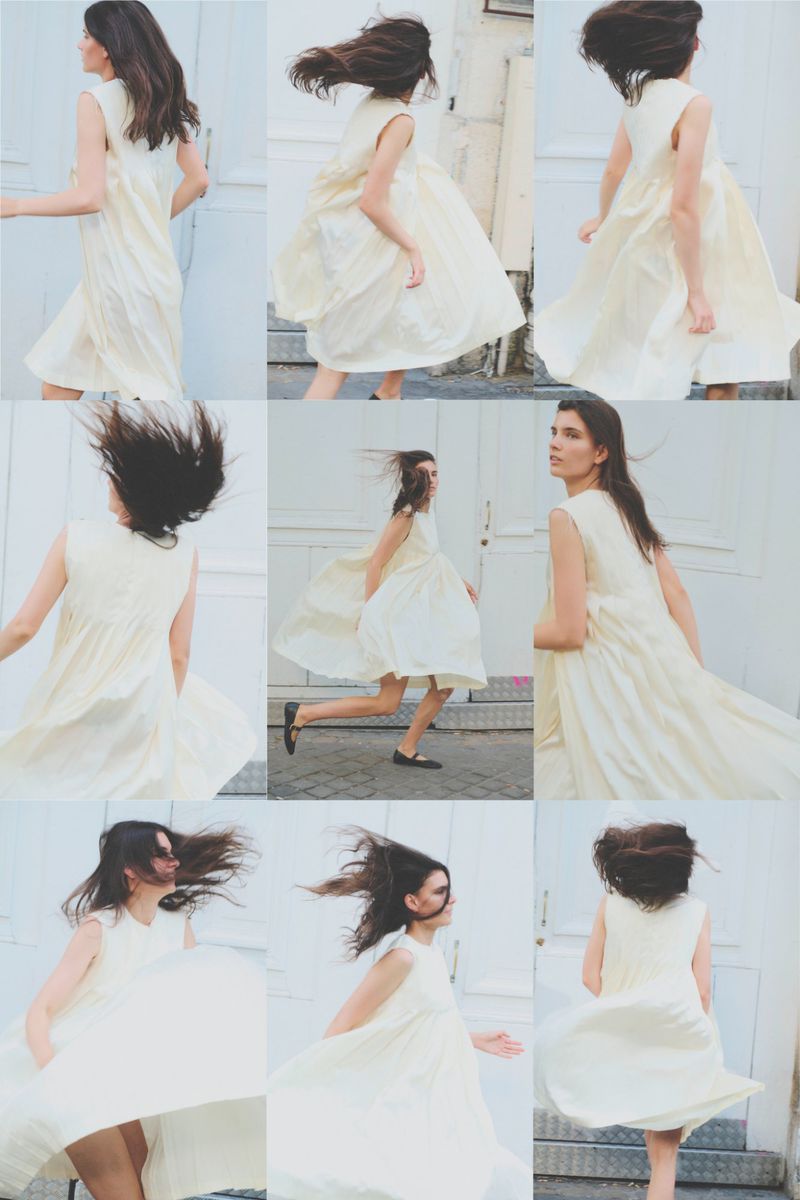 A nine-frame photo grid showing a woman in a flowing cream sleeveless dress spinning and moving against a white building exterior.