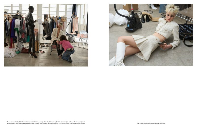 Fashion editorial photo shoot in a studio features a fair-skinned female model, a Black model, and a person assisting the fair-skinned model.