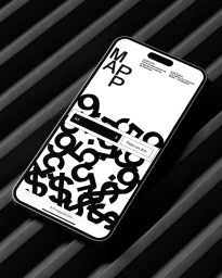 Smartphone displaying a monochrome graphic mobile interface for MAPP festival on a slatted dark industrial surface.