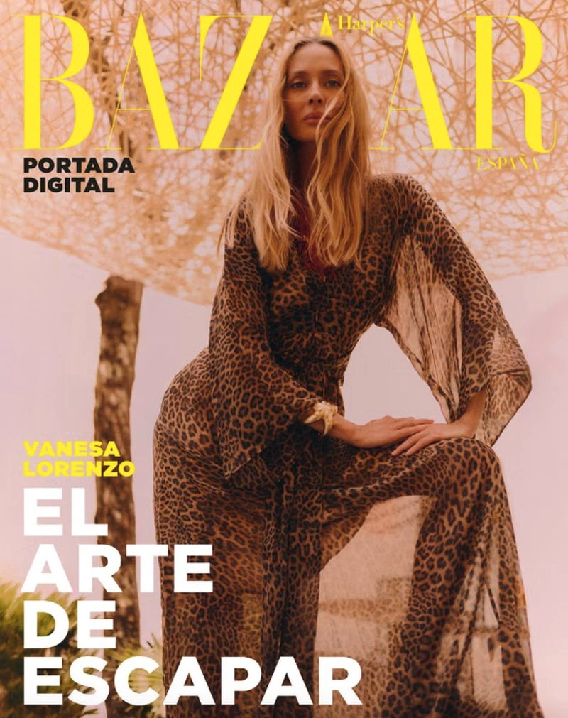Vanesa Lorenzo wearing a sheer leopard print maxi dress outdoors under a woven canopy for Harper's Bazaar España.