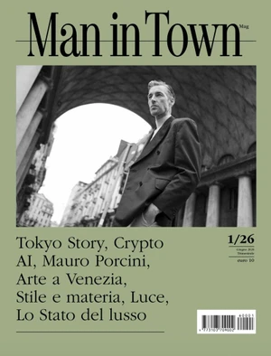 Magazine cover of Man in Town featuring a man in a dark double-breasted blazer standing before an arched architectural colonnade.