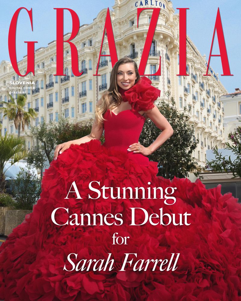 Sarah Farrell posing in a voluminous red ruffled ballgown in front of the Carlton hotel exterior for a magazine cover.