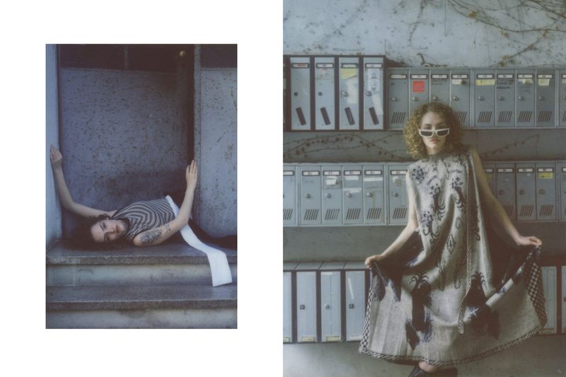 Fashion editorial shot with a model lying on steps in a striped top and a model in a patterned dress posing by mailboxes.