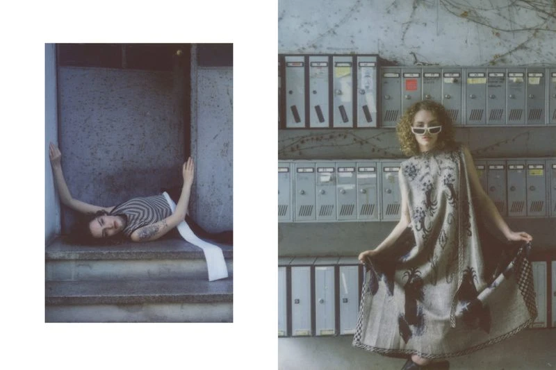 Fashion editorial shot with a model lying on steps in a striped top and a model in a patterned dress posing by mailboxes.