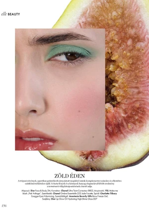 Beauty editorial close-up of a woman with green eyeshadow layered over a sliced ripe fig on a white magazine page.