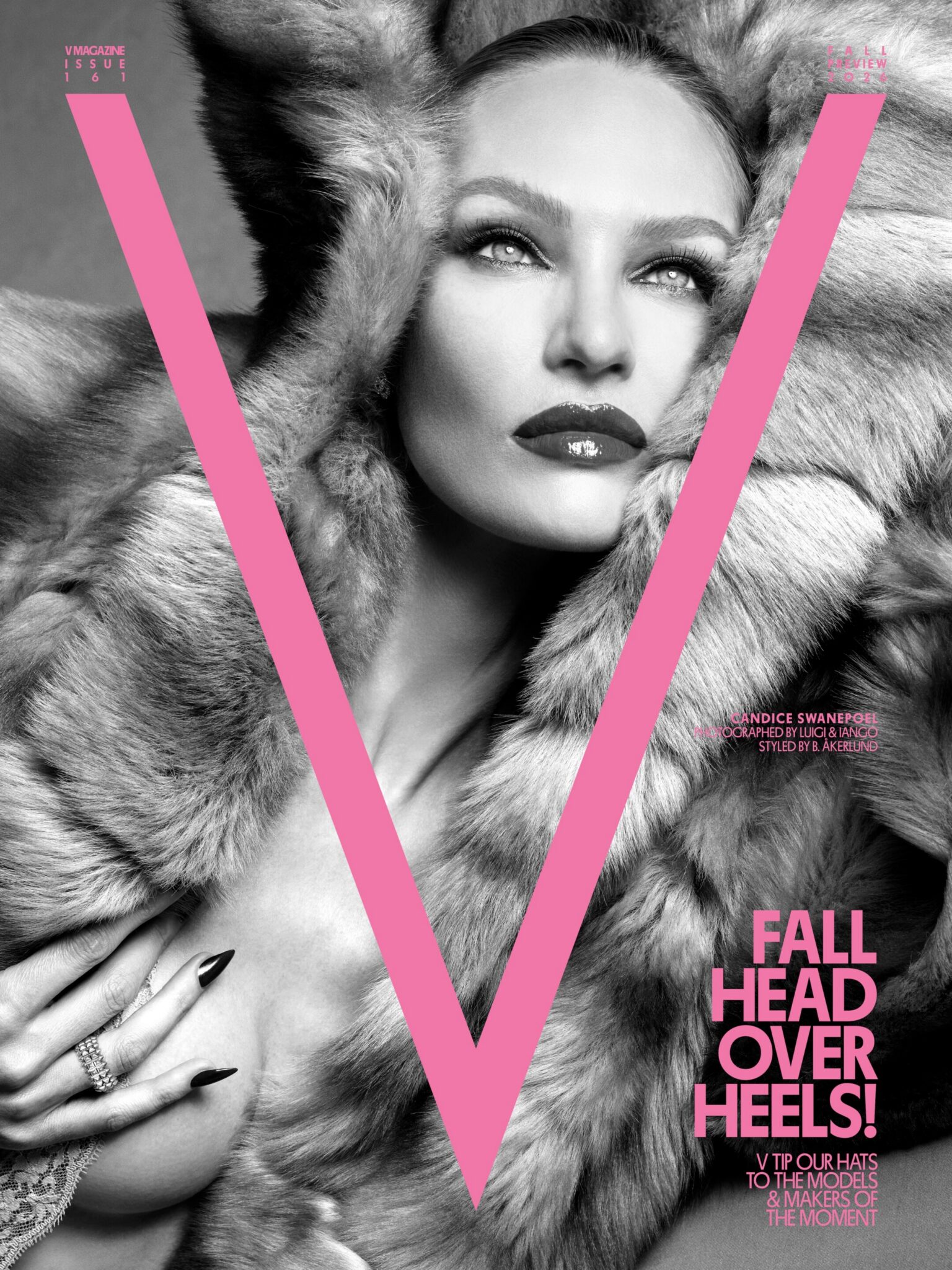Candice Swanepoel wrapped in a voluminous fur hood on the black and white cover of V Magazine with a bold pink V overlay.
