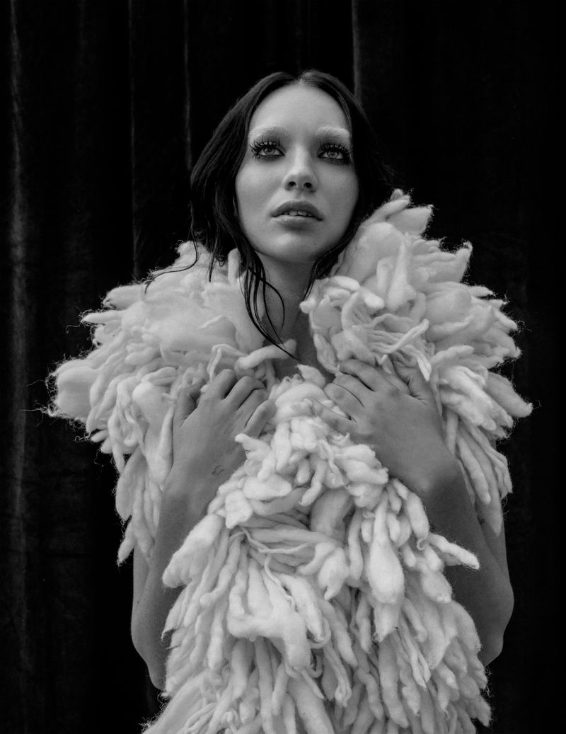 Maddie Ziegler wearing a textured white fluffy garment in a black and white editorial portrait for DSECTION Magazine.