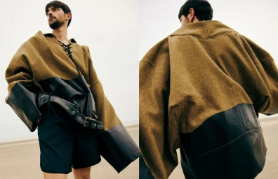 Model Hannes Gobeyn wearing an oversized camel wool and black leather top on a beach for Luxiders Magazine editorial.