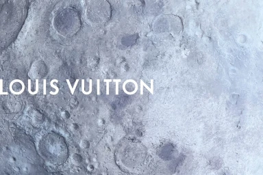 White Louis Vuitton typography overlaid on a grey and slate blue textured lunar surface with craters.