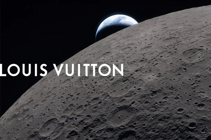 Lunar surface with visible craters and Earth rising in space with the Louis Vuitton text overlay.