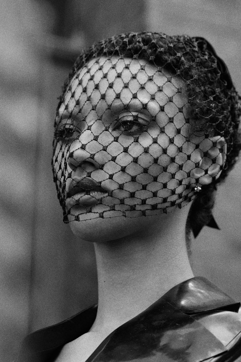 Close-up monochrome portrait of Georgia Palmer wearing a netted veil covering her face for Harper's Bazaar Turkey.