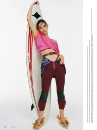Model Mathilda Gvarliani holding a surfboard against a white background for Financial Times HTSI Magazine