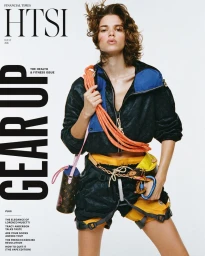 Mathilda Gvarliani wearing a climbing harness, coiled orange rope, and windbreaker on the cover of Financial Times HTSI Magazine.