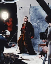 Behind the scenes look at Willy Chavarria shoot for Man About Town with model in velvet coat and red gloves