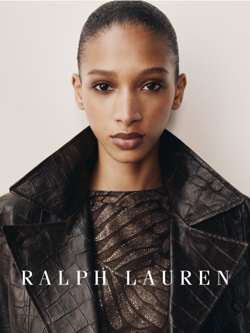 Model wearing a dark brown crocodile-embossed leather coat against an off-white studio backdrop in a Ralph Lauren portrait.