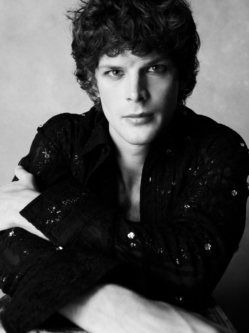Black and white portrait of model Jules Santiago wearing an embellished dark shirt with crossed arms.