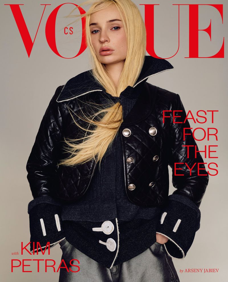 Kim Petras posing on the cover of Vogue Czechoslovakia in a black quilted jacket against a neutral studio backdrop.