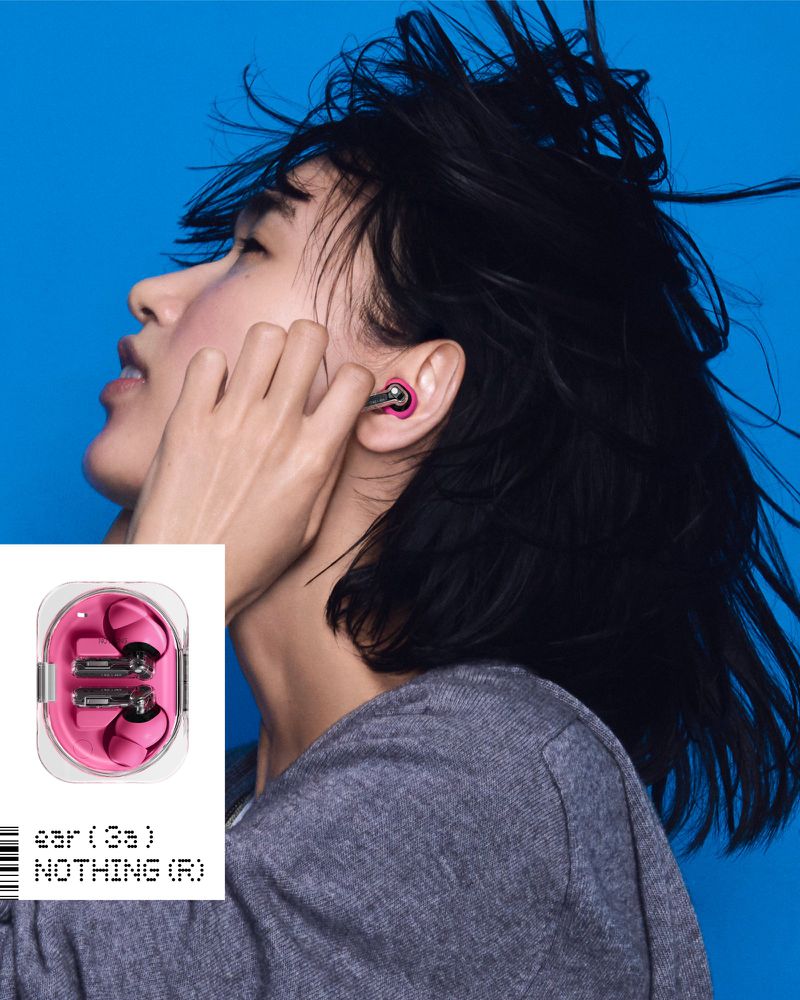 Model wearing a pink Nothing wireless earbud against a vibrant blue backdrop with product case graphic inset.