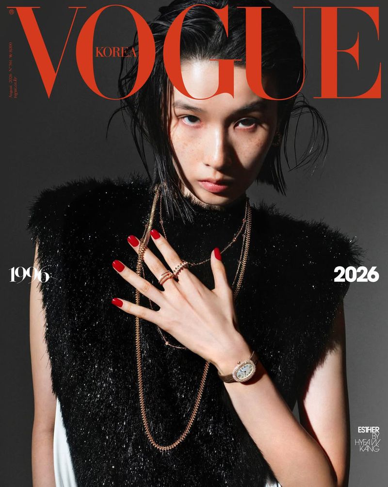 Model Esther Kim posing for Vogue Korea cover wearing a black textured sleeveless top, layered gold jewellery, and red nails.